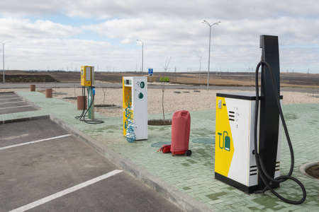 Industrial vacuum cleaner and stationary compressor for inflating wheels at a gas station. Electric vehicle charging station, in the countrysideの写真素材