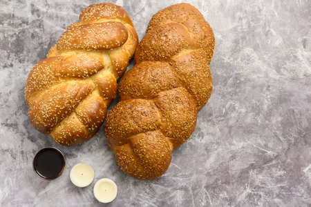 Shabbat Shalom - challah bread, shabbat wine and candles on table. Top view.の写真素材