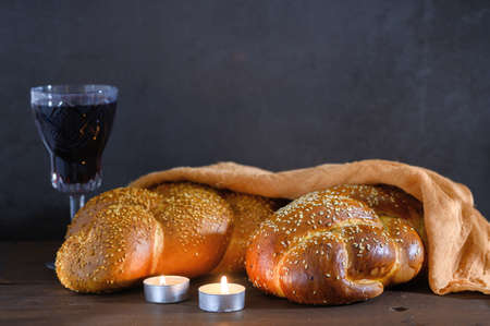 Shabbat Shalom - challah bread, shabbat wine and candles on wooden table.の写真素材