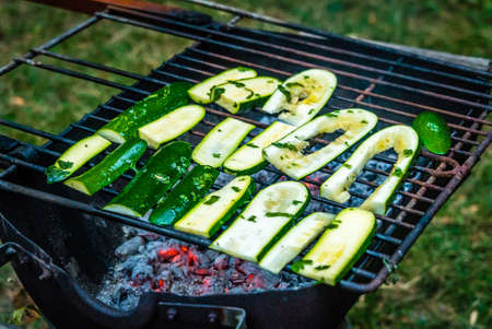 Grilled cucumbers with oil on the barbecue a summer nightの写真素材