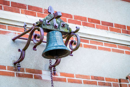 Old outdoor bell that used to be rung at schoolの写真素材