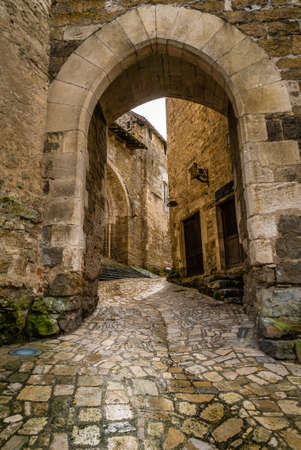 Paved street and arch in Carennac in Vallee-de-la-Dordogne in France