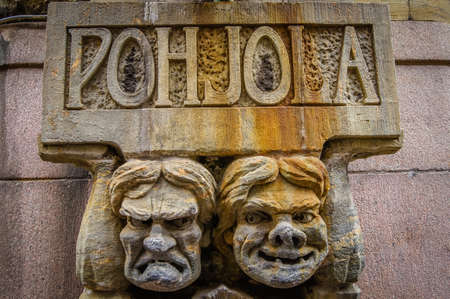Funny faces sculpted in the walls of the houses in Helsinki, Finlandの写真素材