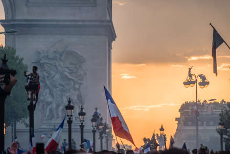 People on the street lights in Paris after the 2018 World Cup