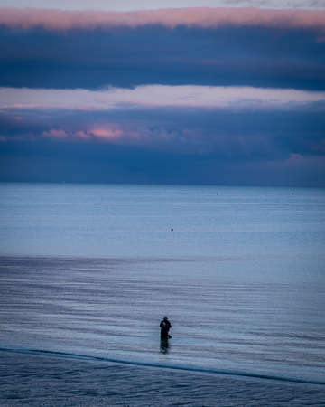 Fisher fishing in Brittany in France at duskの写真素材