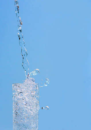 Water pouring into glass の写真素材