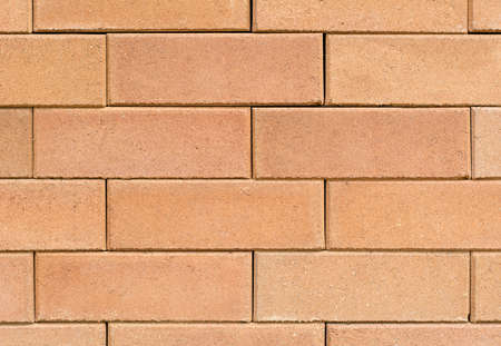Background of orange brick wall close-up