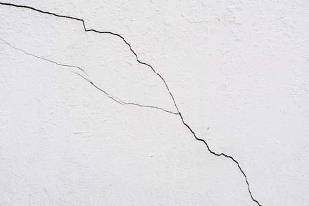 The old white wall with cracks