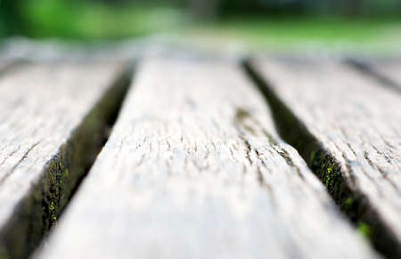 Short depth of field gray wooden boardwalk weathered with rough textured and moss12e1の写真素材