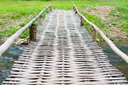 Old wooden bridge over the riverの写真素材