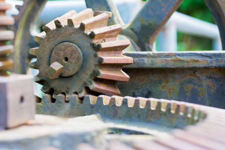 Old and rusty pinion gear of a machine on watergate