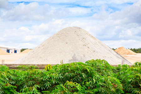 A pile of sand sits in the yard of a concrete manufacturing facilityの写真素材