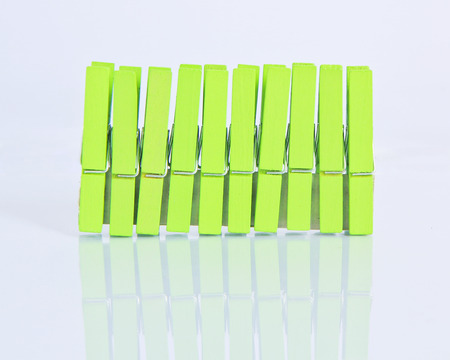 row of wooden clothes green pin.の写真素材