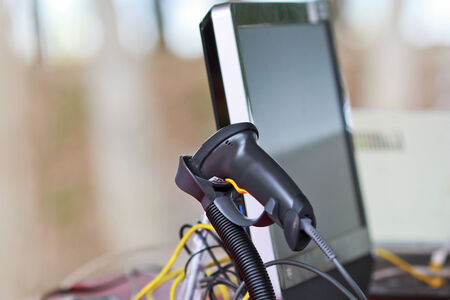 Back of black barcode scanner with monitor.