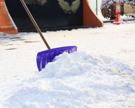 snow shovel standing in the snow.の写真素材