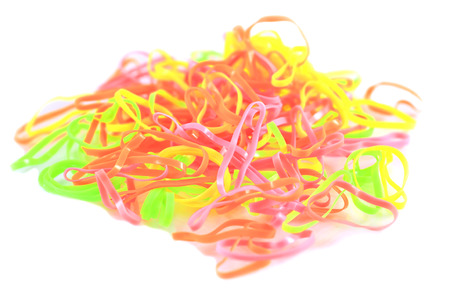 Colorful rubber bands on white background.