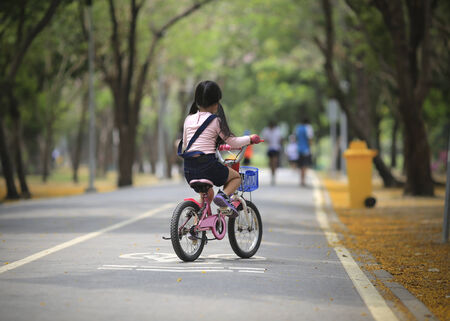 Young girl on the bicycle at Park.の写真素材