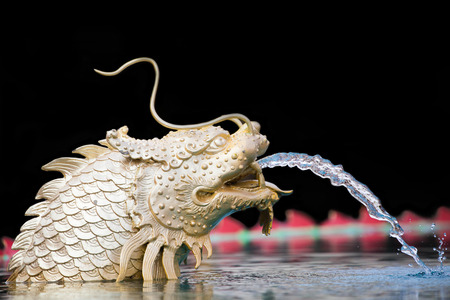 Statue of Chinese dragon fish out of water.の写真素材