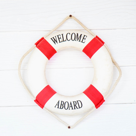 White Life buoy with welcome aboard on white wall.の写真素材