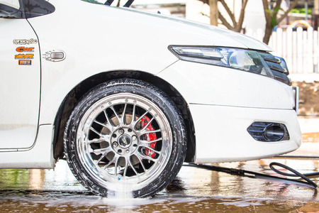 Car wash with flowing water and foamの写真素材