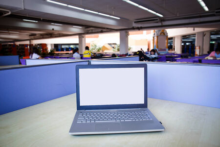 Laptop with blank screen on table