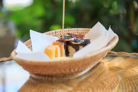 Slice of bread with cream cheese on wood tray.の写真素材