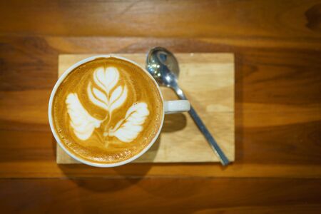 cappuccino cup on the brown wooden table.の写真素材