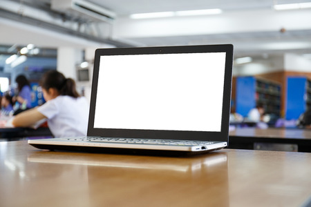 laptop with blank screen on the table in library.の写真素材