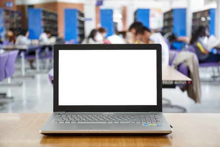 laptop with blank screen on the table in library.の写真素材
