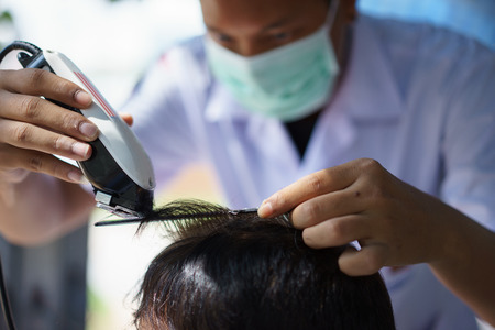 men's haircut with clipper in the barber shop.の写真素材