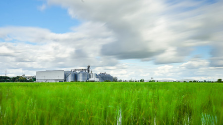 Factory in blur green field with cloud move slowly.の写真素材