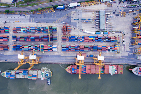 Aerial View Above the Bangkok Dockyard by the Chao Phraya River with Cargo Ships Waiting to be Upload and Offload Cargo Containers.の写真素材