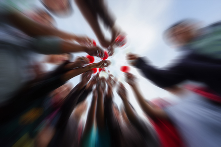 Blurred soft people are give a wine glass for background.の写真素材