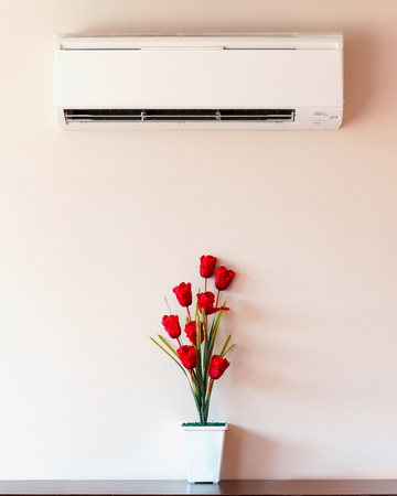 Air conditioner and flower vase with wall.の写真素材