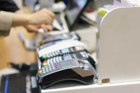 Man using pos terminal at the shop (paying credit card for purchases)の写真素材