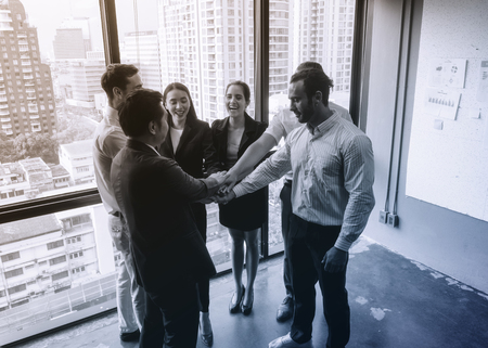 Business team is holding hands in an office buildingのeditorial素材