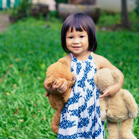 Cute little girl with a bearの写真素材