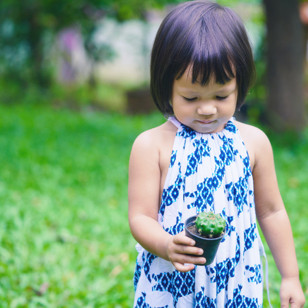 Cute little girl with cactus potの写真素材