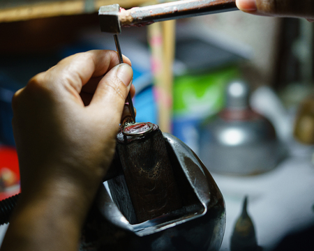 Close up of a jeweler's hands doing a repair