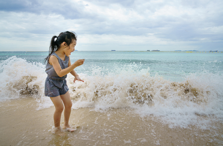 Little girl with the sea wave.の写真素材