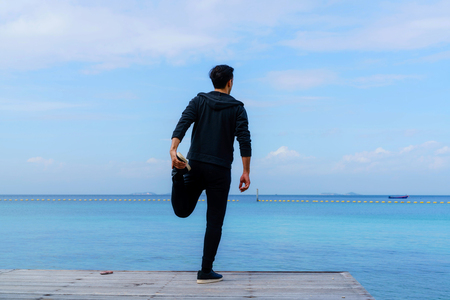 Man training on beach outside.の写真素材