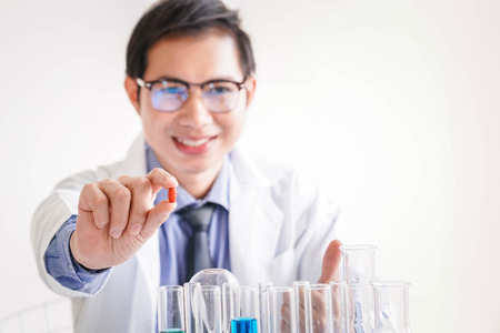 Doctor in red holding a pillの写真素材