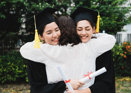 A graduate hugging her mother.の写真素材