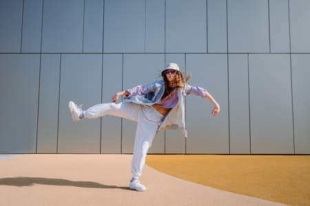 Dancing girl funny break dance, happy rhythmically waving. Playful crazy girl dance emotions. Breakdancing, street dancing, hiphop, freestyle dance.の写真素材