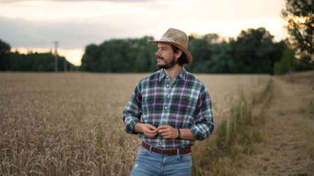 Young farmer, business owner looks at the camera in the fieldの写真素材