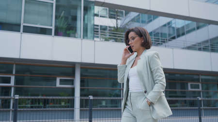 Successful female going to office in modern business centerの写真素材