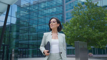 Business woman go to working at office building district in morning rush hourの写真素材