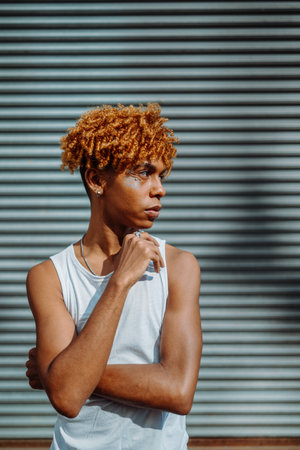 Side view of the confident teenager with creative makeup posing outdoorsの写真素材