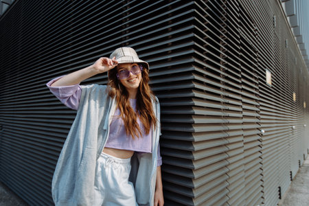 Fashionable funky caucasian girl dancer in sportswear is performing outdoor street dancing motion .の写真素材