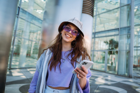 Young caucasian girl smiling happy using smartphone at city.の写真素材